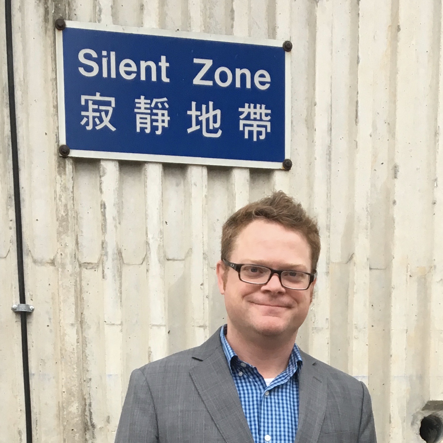 In Hong Kong in front of "Silent Zone" sign
